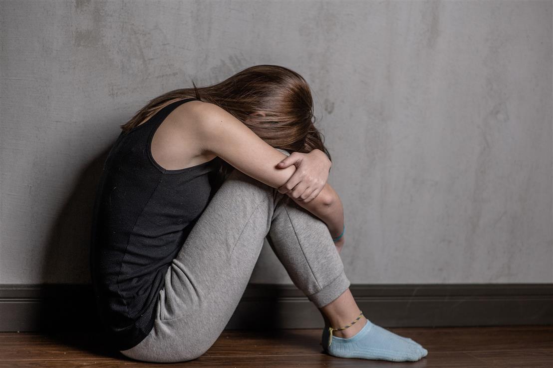 scared woman sitting on floor